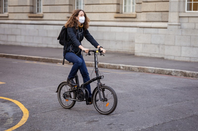 Sporting a face mask against COVID-19 while out and about cycling in the city